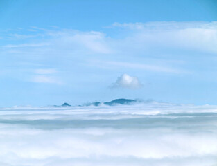 peak mountain with sunlight cloud fog and bright blue sky