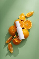 Top view of cosmetic jar decorated with orange in green background