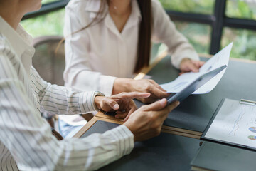 Coworker business concept, Two businesswoman checking report to discussing new project together
