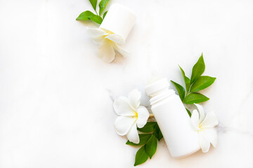 Obraz na płótnie Canvas roll on deodorant antiperspirant fragrance flower frangipani health care for surface armpit arrangement flat lay style on background wooden