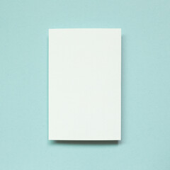 Blank white memo paper on blue background. top view, copy space