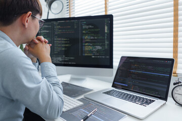 Software development concept, Male programmer read data code to thoughtful about developing website