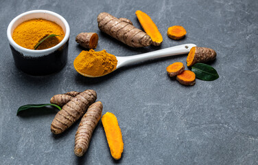 curcuma or curcumin root. Turmeric powder and fresh turmeric. on concrete background. Spice, natural coloring, alternative medicine. top view