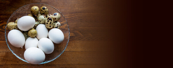 background of quail spotted and chicken white eggs in a saucepan. Quail eggs on white dish, There are many sizes and patterns are different. bunner with copy space