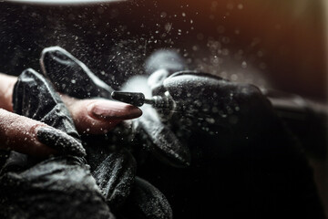 The master uses an electric machine to remove the nail polish during manicure in the salon....