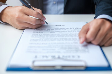 Businessman signing on contract documents after reading, man holding pen and approve on business report. Contract agreement, partnership and deal concepts