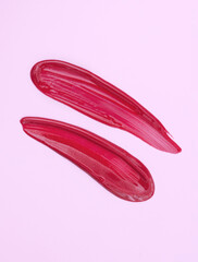 lipstick smear sample lip gloss on pink background