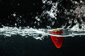 Concept of freshness, fresh strawberry against dark