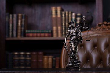 Judge office. Themis sculpture and gavel on the judge desk. Book shelf and judge chair in the...