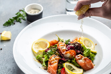 Salmon fish salad. Fresh vegetable lettuce and salmon fish fillet, healthy food, omega 3, keto diet, mediterranean cusine top view