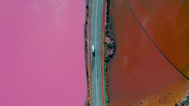 Aerial video of a car going across Pink lake, Hutt Lagoon, Port Gregory, Western Australia