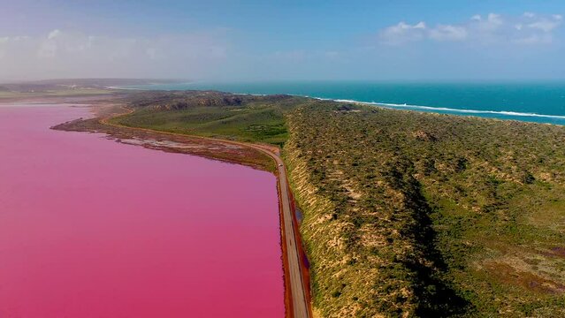 Aerial video of Pink lake and blue ocean, Hutt Lagoon, Port Gregory, Western Australia