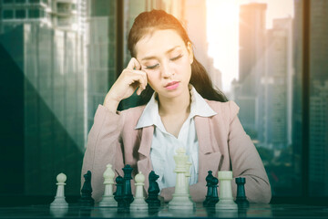 Confused businesswoman playing chess game