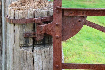 old fence post and rusty gate