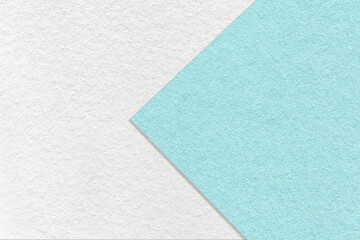 Fototapeta na wymiar Texture of white and light blue paper background, half two colors with arrow, macro. Structure of turquoise cardboard.