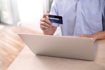 shopper using laptop online shopping. And using credit card online payment option or digital wallet online transaction.
