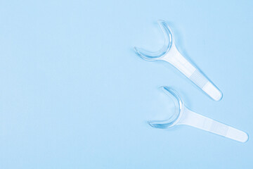 Fototapeta na wymiar set of several Retractor Dental lip retractor Access to the oral cavity. Wide mouth opening for a dental procedure on a clean blue background