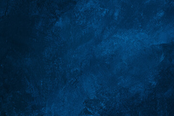 Dark blue colored abstract textured background. Decorative plaster on the wall