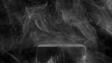 Glitter mist background. Steam flow. Cosmic stardust. White powder vapor floating over dirty ink drip cube edge on dark night black abstract grain texture.