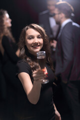 happy young woman raising glass in toast