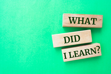 What did I learn? words on wooden blocks on green background.