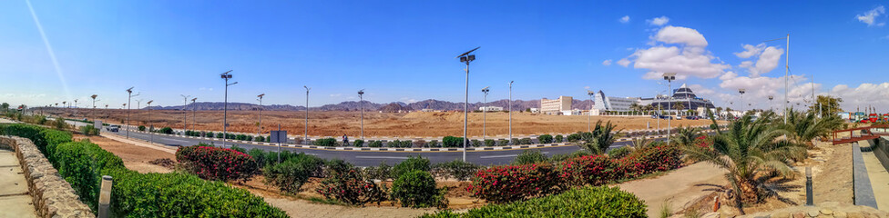 Beautiful panorama of Sharm El Sheikh - Egyptian tourist city in the desert. Palm trees, bushes...