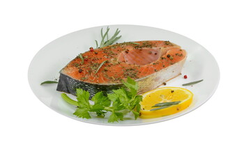 Portioned raw salmon chop on plate with lemon and rosemary isolated on white.