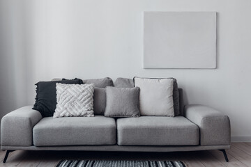 minimalism home interior, gray color palette. Sofa with pillows.