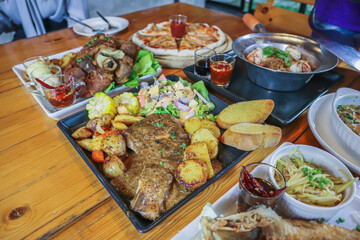 A variety of dishes are laid out on the table to prepare for family and friends banquets during New Year's Eve. Diverse food preparation ideas for family and friends parties during the festive season.