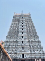 Hindu Shiva temple at Thiruvannamalai in Tamilnadu. Temple tower against blue sky background.
