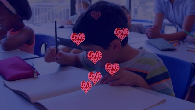 Animation of red hearts over diverse schoolchildren and techer in classroom - Powered by Adobe