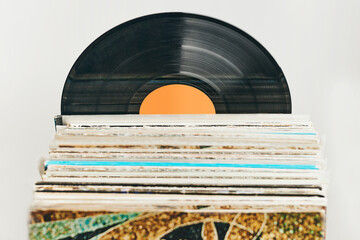 Stack of vinyl records. Listening to music from record. Playing music from analog record. Retro...