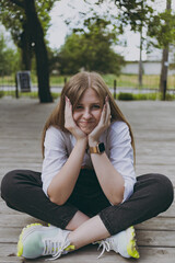 A girl in a white shirt in the city