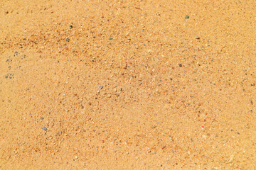 Top view bright vivid river sand background. River sand texture. Sand background. Summertime. Football, volleyball beach sports concept.