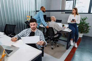 Fototapeta premium Group of young business people working in office together