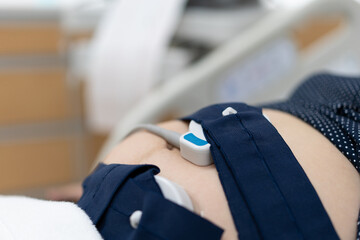 Pregnancy care. Fetal heartbeat monitoring by cardiotocography from electronic fetal monitor....