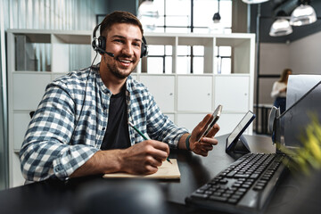 Customer service support operator man with headphones and microphone talking to client in call...