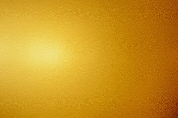 Gold wall texture background. Yellow shiny gold foil on concrete wall surface, vibrant golden...