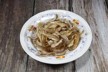 Deep fried crispy and crunchy small fish serving on the plate. Famous appetizer menu in restaurant. 