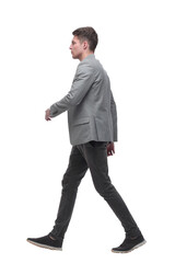 serious young man stepping forward. isolated on white