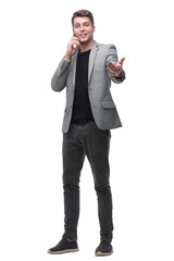 handsome man talking to a mobile phone and pointing to a copy of the space