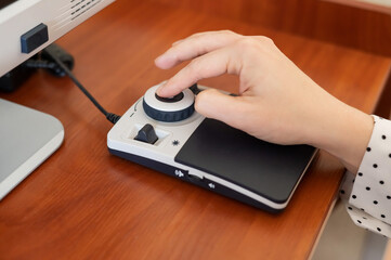 A woman uses a special magnification device for the visually impaired.