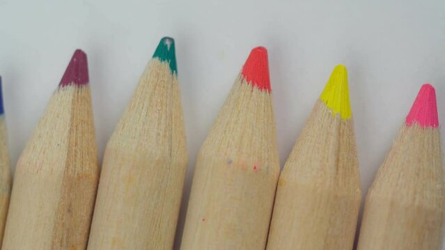 Colored pencils close up macro. Placed on a white background and bright.