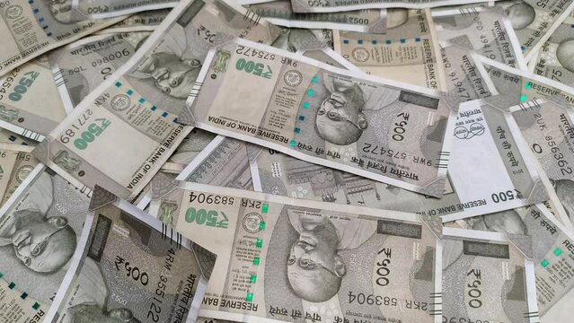 New five hundred rupee india currency bank paper note cash falling over table filled with heap of scattered money. wealth, finance, Loan, savings, success, income, print, printing, rich, tax concept.