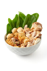 Boiled instant noodles in a large white bowl isolated on white background. This bowl of noodles consisting of instant noodles, seasoning powder, meatballs, pork, and vegetables. popular fast food.
