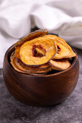 Dried peach slices. Sliced dried peaches on a dark background. Sun-dried fruit. Close-up.