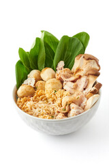 Boiled instant noodles in a large white bowl isolated on white background. This bowl of noodles consisting of instant noodles, seasoning powder, meatballs, pork, and vegetables. popular fast food.