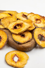 Dried peach slices. Sliced dry peach isolated on white background. Sun-dried fruit. Close up