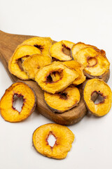 Dried peach slices. Sliced dry peach isolated on white background. Sun-dried fruit. Close up