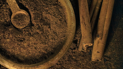 cinnamon ground sticks ceremony cocoa cloves ground coffee spices on wooden table closeup